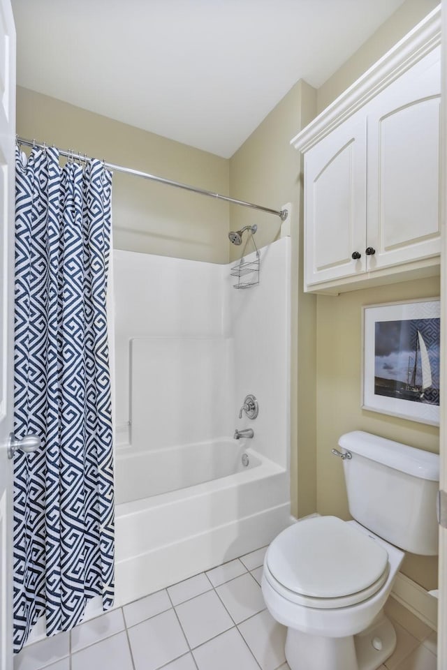 bathroom featuring tile patterned floors, shower / bath combo with shower curtain, and toilet