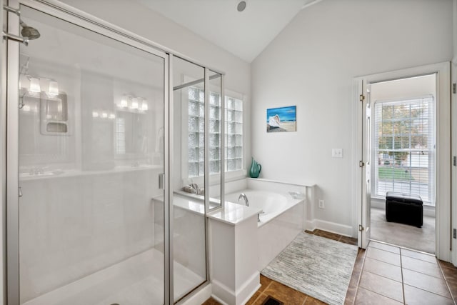 bathroom featuring tile patterned flooring, separate shower and tub, and lofted ceiling