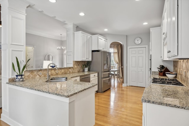 kitchen featuring white cabinetry, sink, kitchen peninsula, and stainless steel appliances