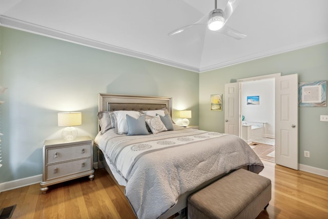 bedroom featuring light wood-type flooring, ceiling fan, crown molding, and connected bathroom