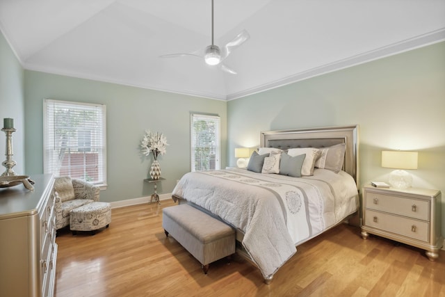 bedroom with ceiling fan, light hardwood / wood-style flooring, crown molding, and lofted ceiling