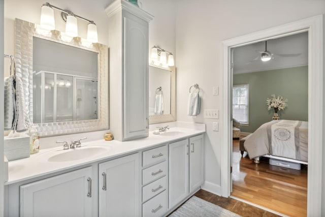 bathroom featuring hardwood / wood-style flooring, vanity, ceiling fan, and a shower with shower door