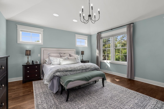 bedroom featuring a notable chandelier, vaulted ceiling, and dark hardwood / wood-style floors