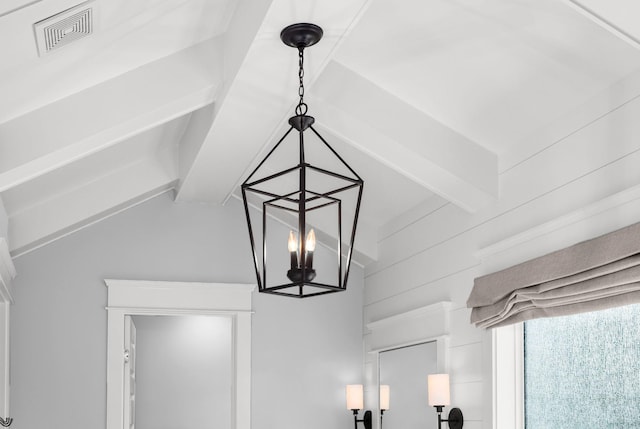 details featuring beamed ceiling and a chandelier