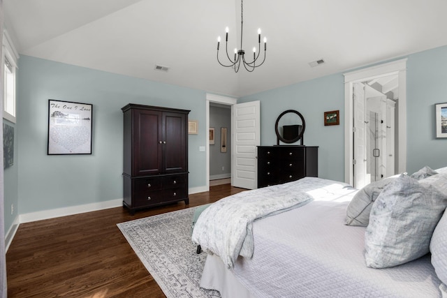 bedroom with an inviting chandelier and dark hardwood / wood-style flooring