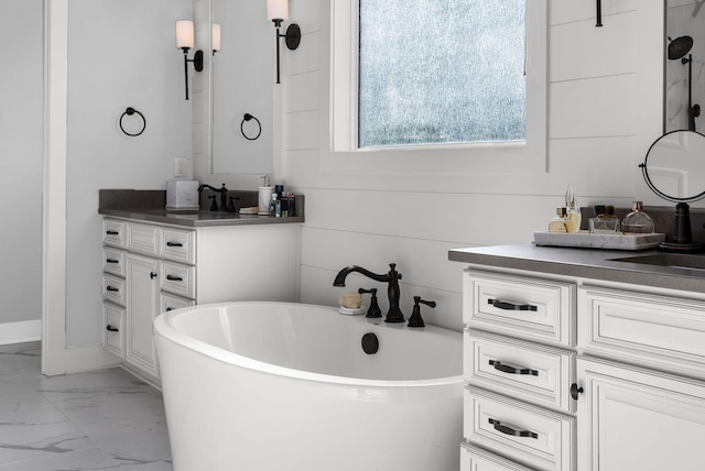 bathroom featuring vanity and a bath