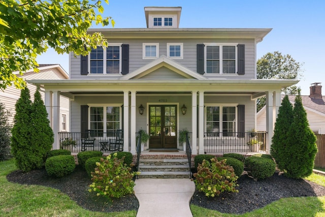 view of front of property featuring french doors and covered porch