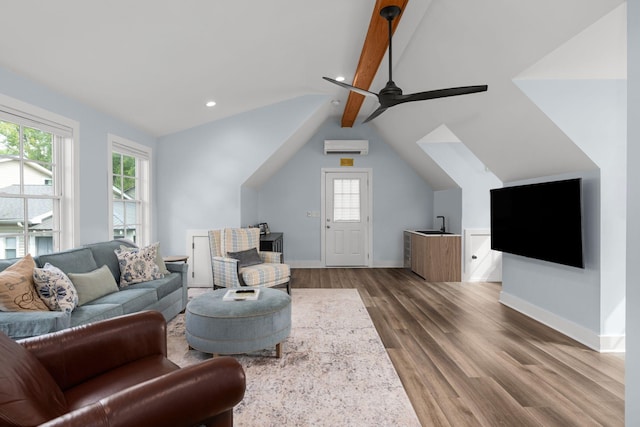 living room with lofted ceiling with beams, an AC wall unit, hardwood / wood-style flooring, and ceiling fan