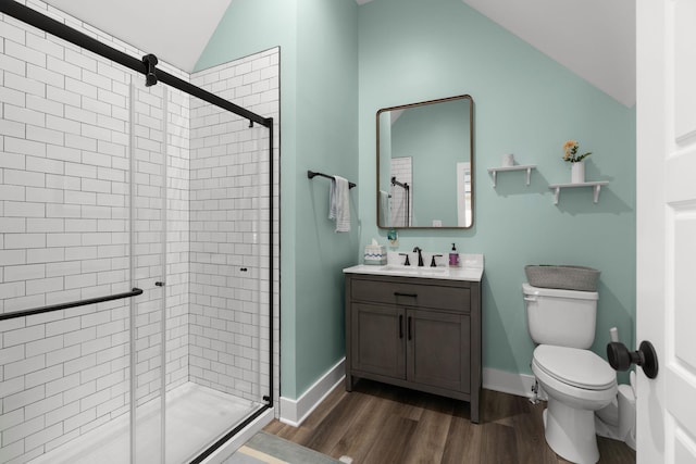 bathroom featuring an enclosed shower, vanity, wood-type flooring, vaulted ceiling, and toilet