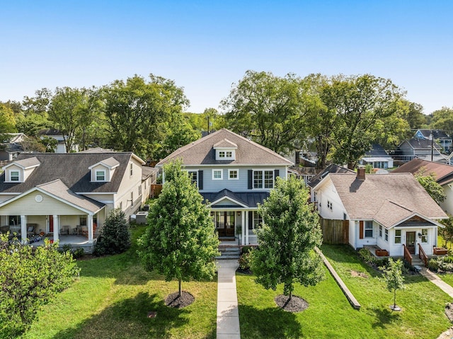 view of front of home with a porch and a front lawn