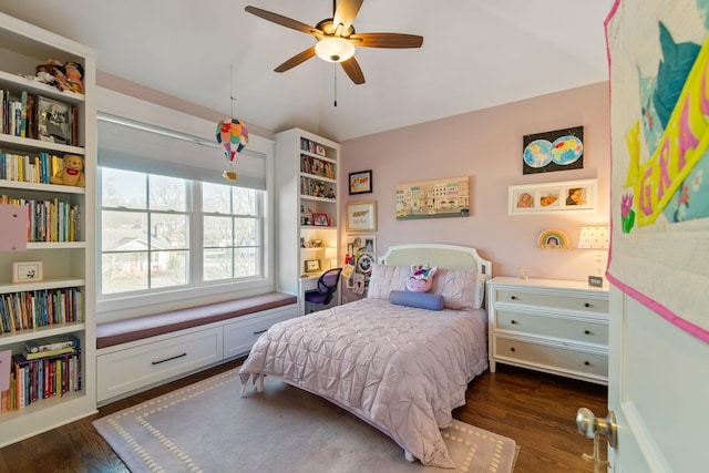 bedroom with dark hardwood / wood-style flooring and ceiling fan