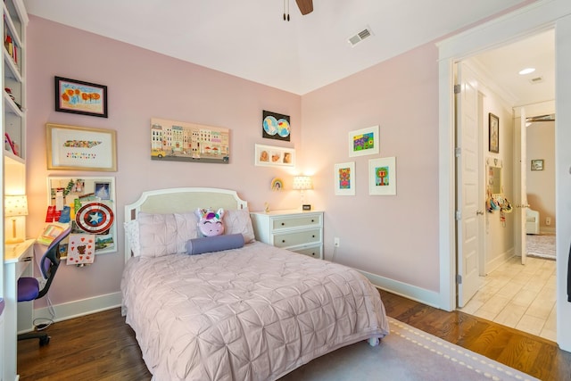 bedroom with dark hardwood / wood-style flooring, ornamental molding, and ceiling fan