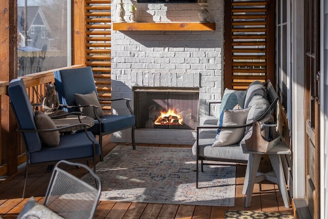 interior space with hardwood / wood-style flooring and a brick fireplace