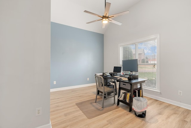 office featuring ceiling fan, vaulted ceiling, and light wood-type flooring