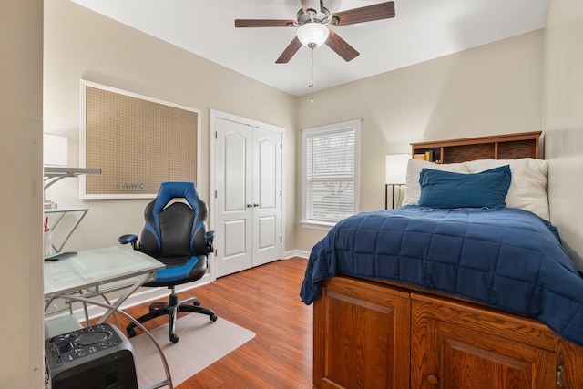 bedroom with a closet, ceiling fan, and hardwood / wood-style floors