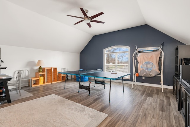 recreation room with ceiling fan, vaulted ceiling, and hardwood / wood-style flooring