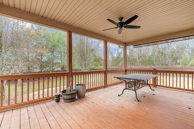 unfurnished sunroom with ceiling fan