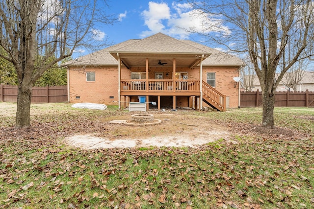 rear view of house featuring a fire pit, ceiling fan, and a wooden deck