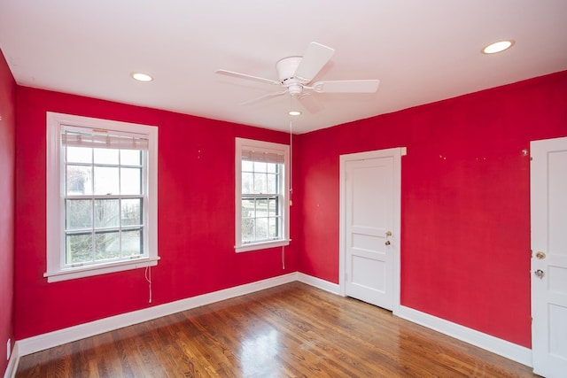 empty room featuring ceiling fan and hardwood / wood-style floors