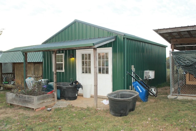 view of outbuilding featuring a lawn