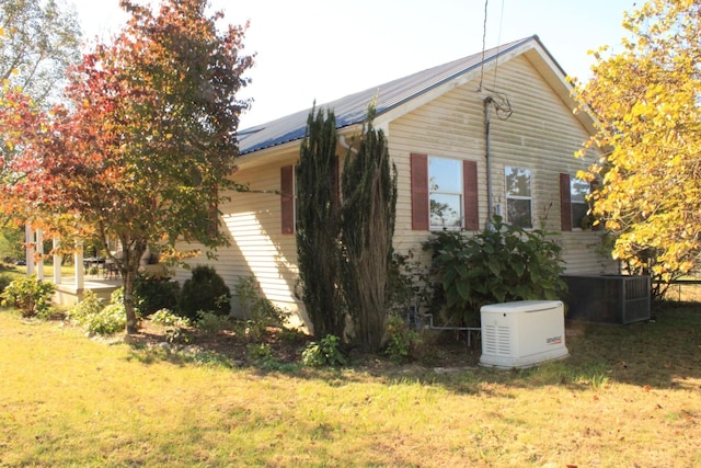 view of property exterior featuring a yard and central air condition unit