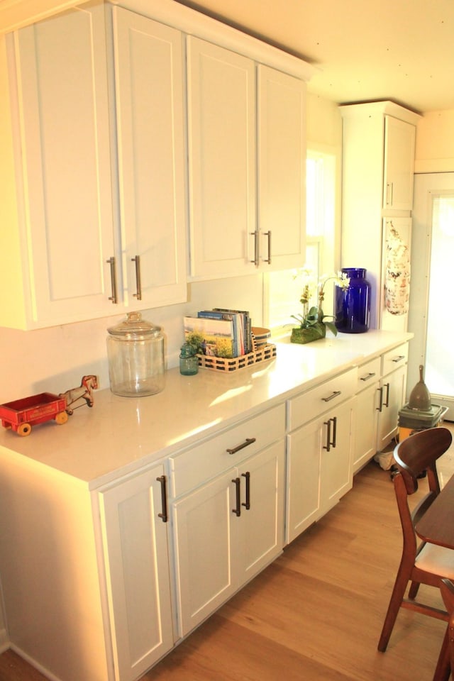 kitchen featuring white cabinets and light hardwood / wood-style floors