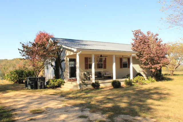 view of front of house with a porch and a front lawn