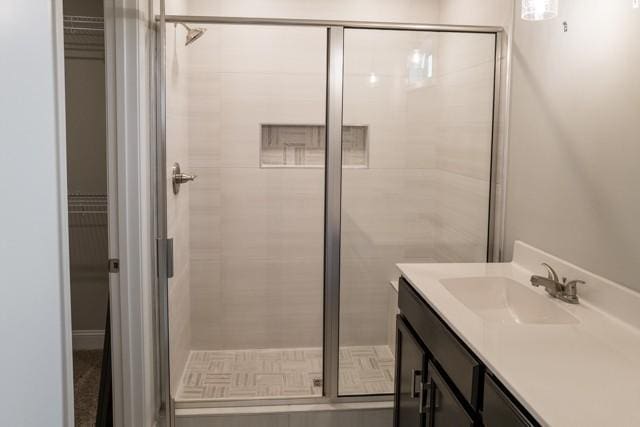 bathroom with vanity and a shower with shower door