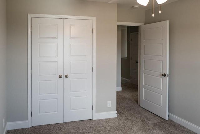 unfurnished bedroom featuring carpet floors and a closet