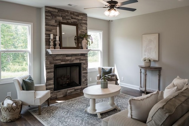 living room with a wealth of natural light and dark wood-type flooring