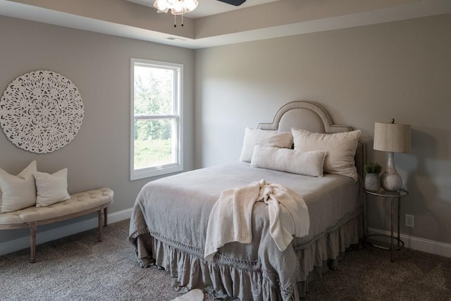 bedroom with ceiling fan and dark colored carpet