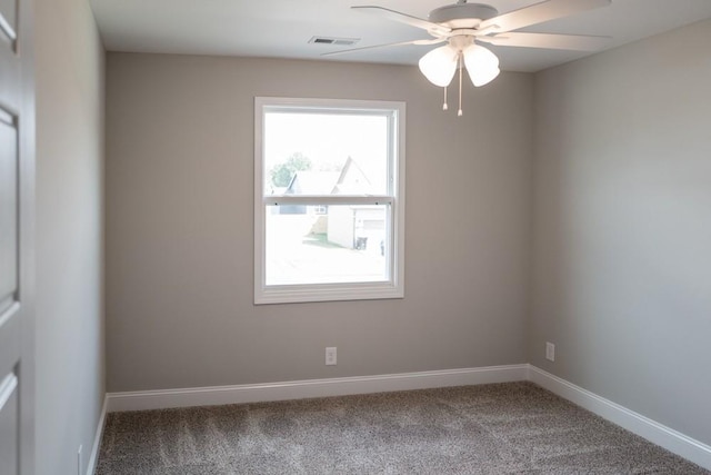 empty room featuring ceiling fan and carpet floors