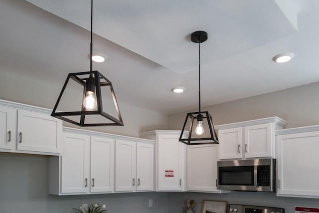 details featuring white cabinetry and hanging light fixtures