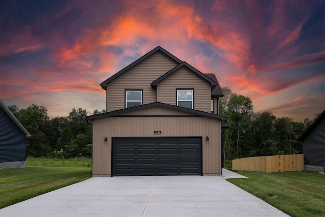 front of property featuring a lawn and a garage