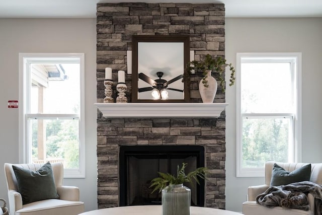 sitting room with plenty of natural light, ceiling fan, and a fireplace