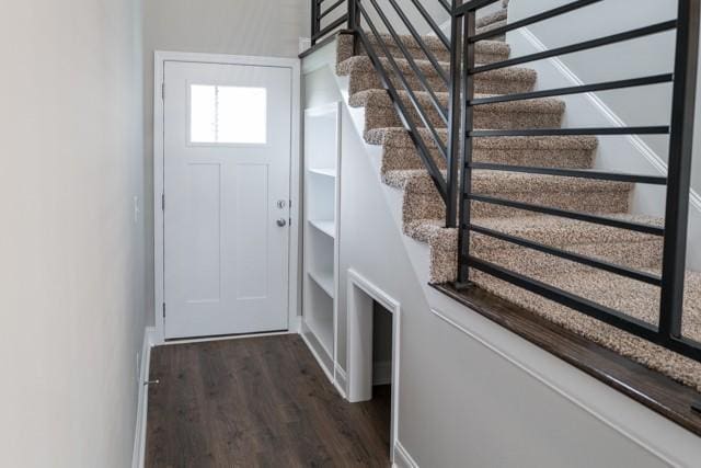 entryway with dark hardwood / wood-style flooring