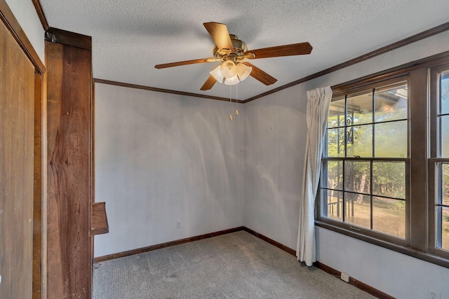 carpeted spare room with ceiling fan and a textured ceiling