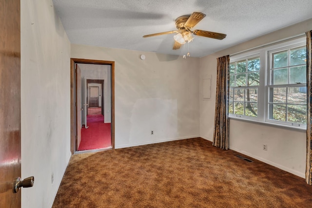 carpeted empty room featuring a textured ceiling and ceiling fan