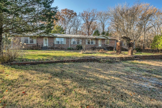 ranch-style home with a front lawn