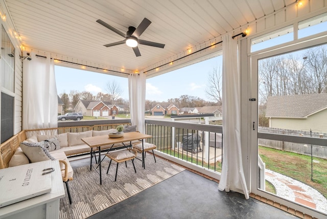 sunroom / solarium with ceiling fan, wood ceiling, and a wealth of natural light