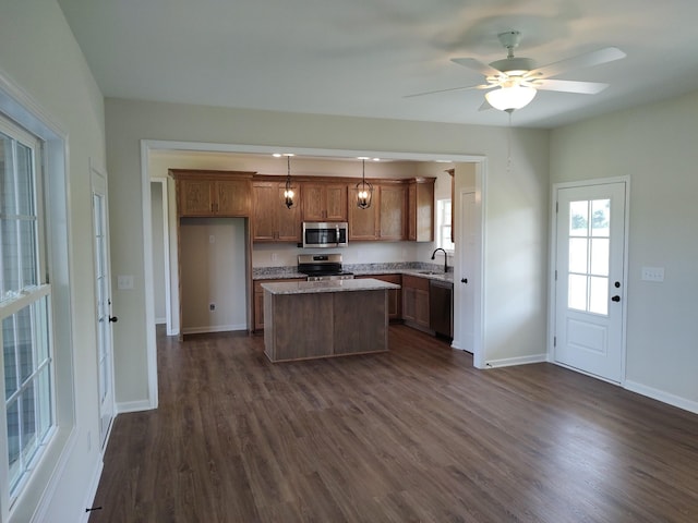 5058 Blue Springs Rd, Smithville, TN 37166 - kitchen with stainless steel appliances, dark wood finished floors, a kitchen island, a sink, and baseboards