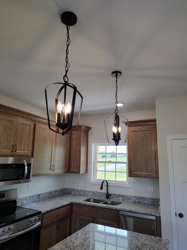 5058 Blue Springs Rd, Smithville, TN 37166 - kitchen with a sink, stainless steel appliances, a chandelier, pendant lighting, and light stone countertops