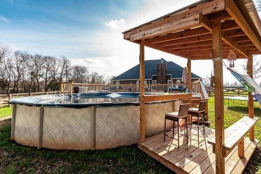 deck featuring a covered pool