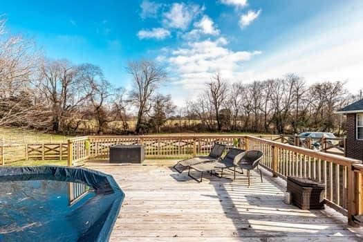 deck featuring a covered pool