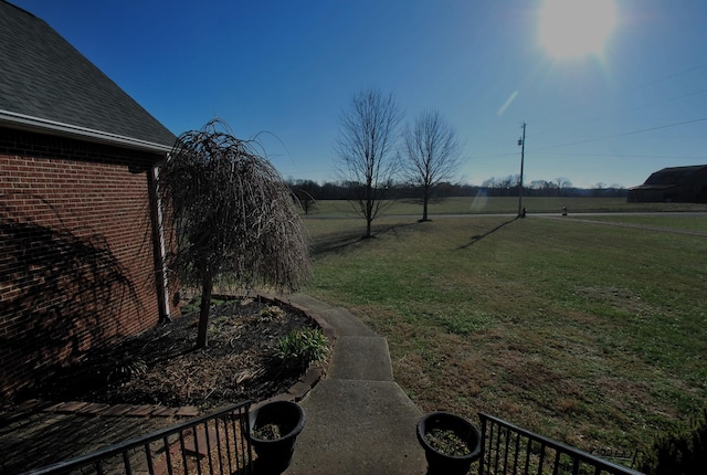 view of yard with a rural view