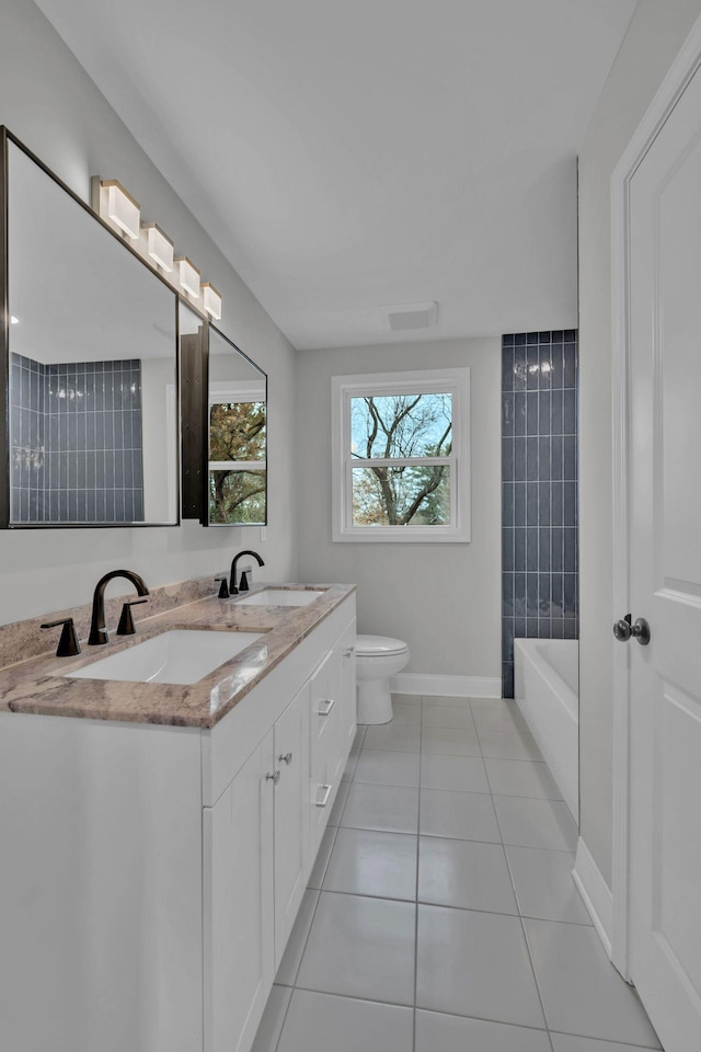 full bathroom featuring tile patterned flooring, toilet, baseboards, and a sink