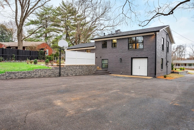 exterior space featuring fence, brick siding, and a chimney