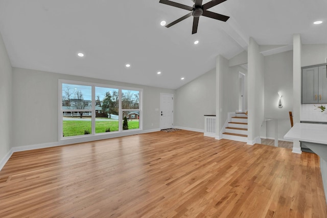 unfurnished living room featuring light wood-style flooring, lofted ceiling with beams, recessed lighting, baseboards, and stairs