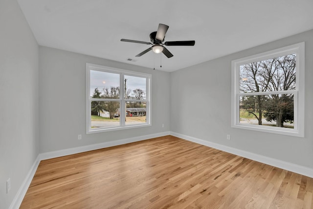 unfurnished room featuring light wood-style flooring, baseboards, and ceiling fan