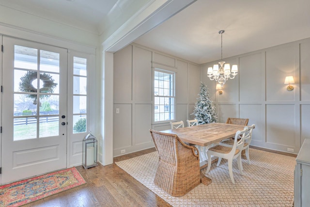 dining area featuring a notable chandelier, plenty of natural light, and light hardwood / wood-style floors